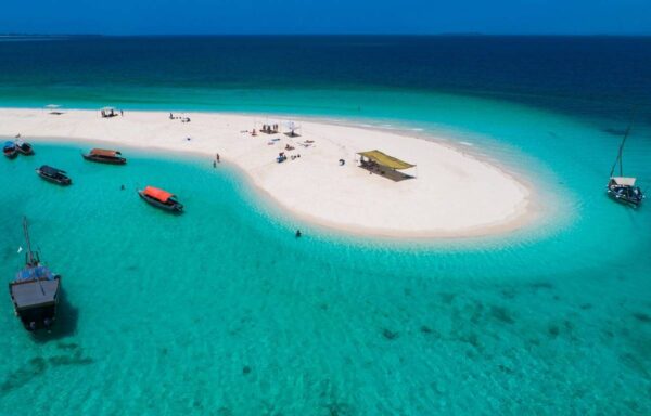 A boat is on the water near an island.