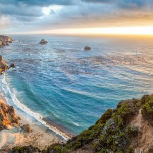 A view of the ocean from above at sunset.