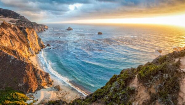 A view of the ocean from above at sunset.